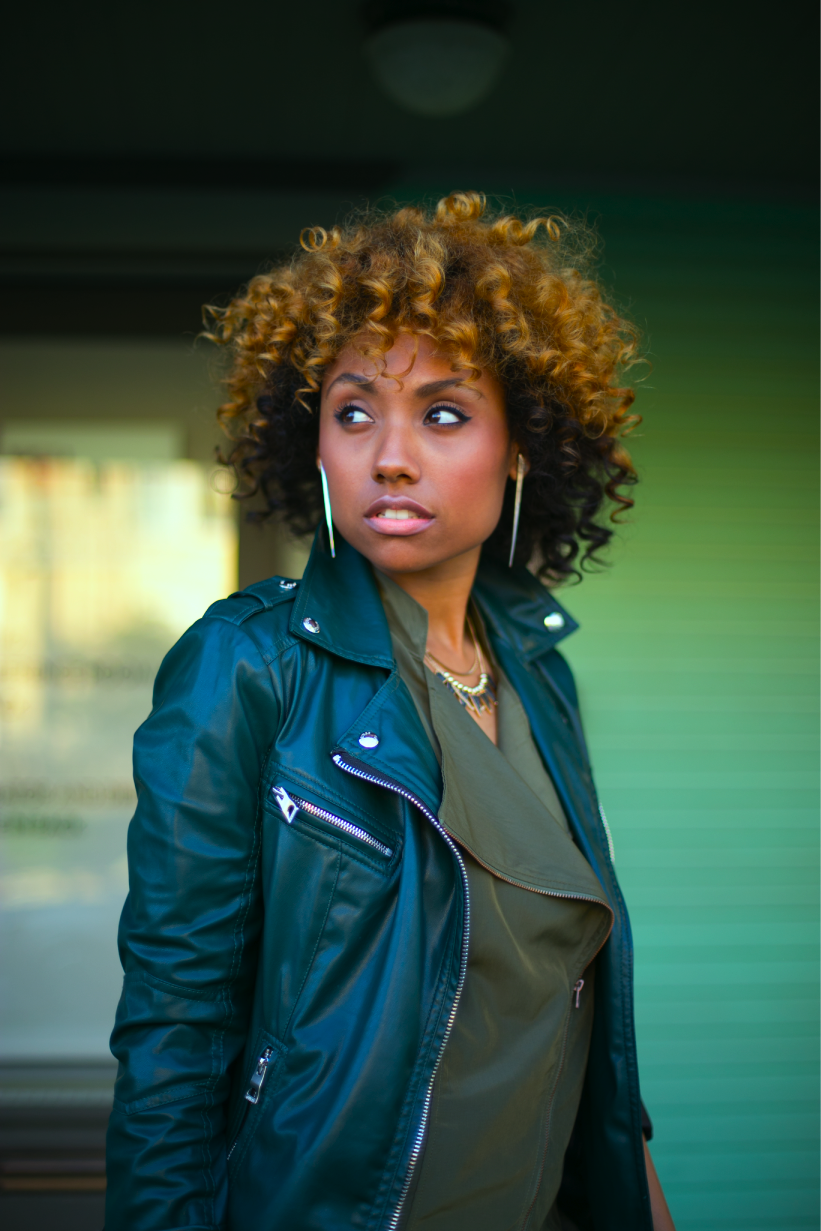 natural hair woman in green outfit