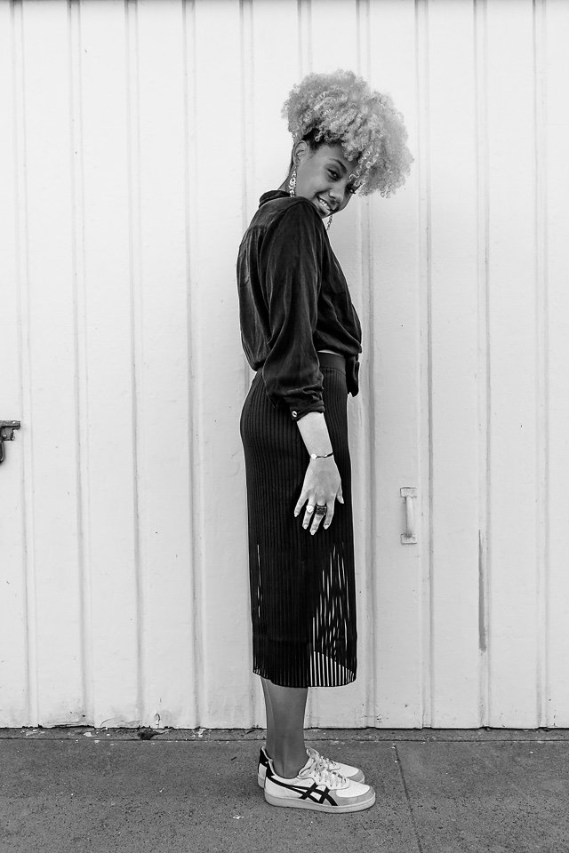 black and white photo of an athleisure outfit-thrift shirt-trendy skirt-livecgothesminded-fit femme
