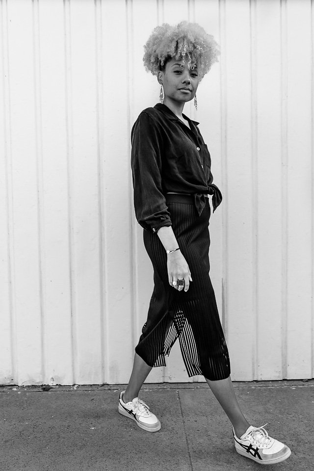 black and white photo of an athleisure outfit-thrift shirt-trendy skirt-liveclothesminded-fit femme