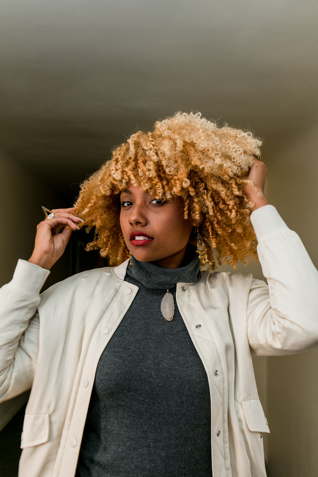 black woman with curly blonde hair