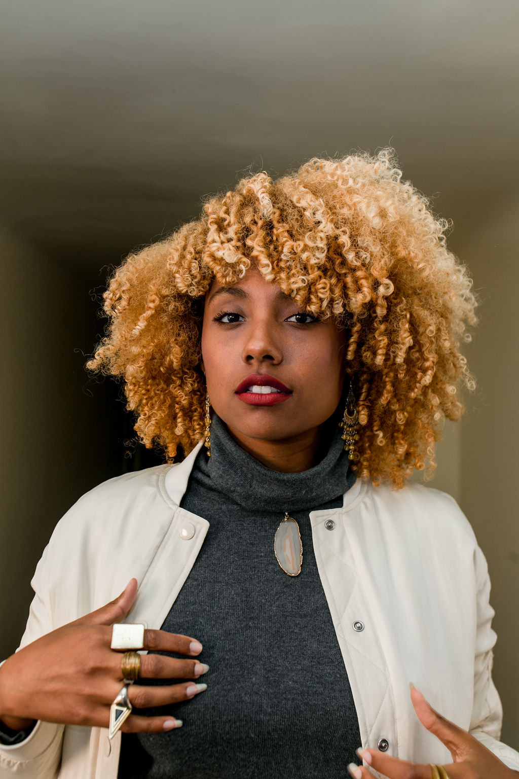 woman with blonde curly hair wearing slacks with sneakers