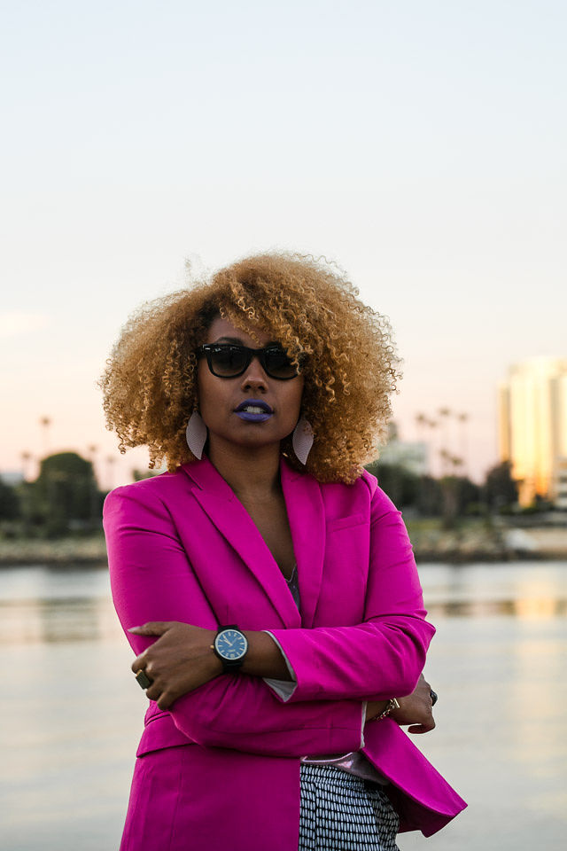 woman wearing wood watch and pink blazer