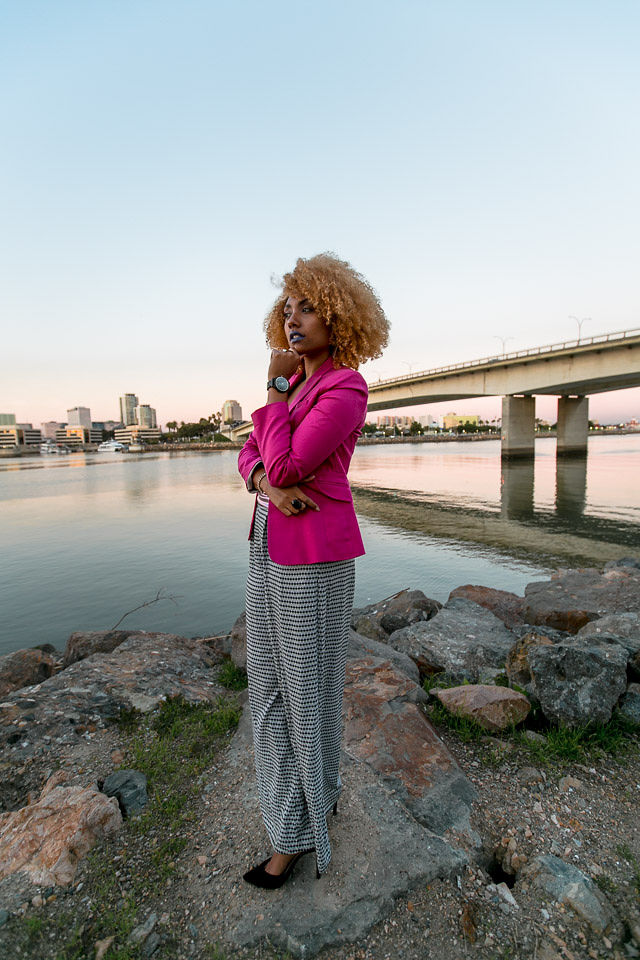 woman in work outfit with pink blazer and wood watch