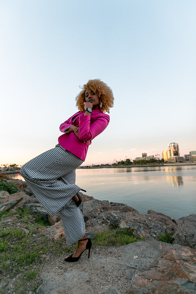 woman wearing pink blazer and wood watch